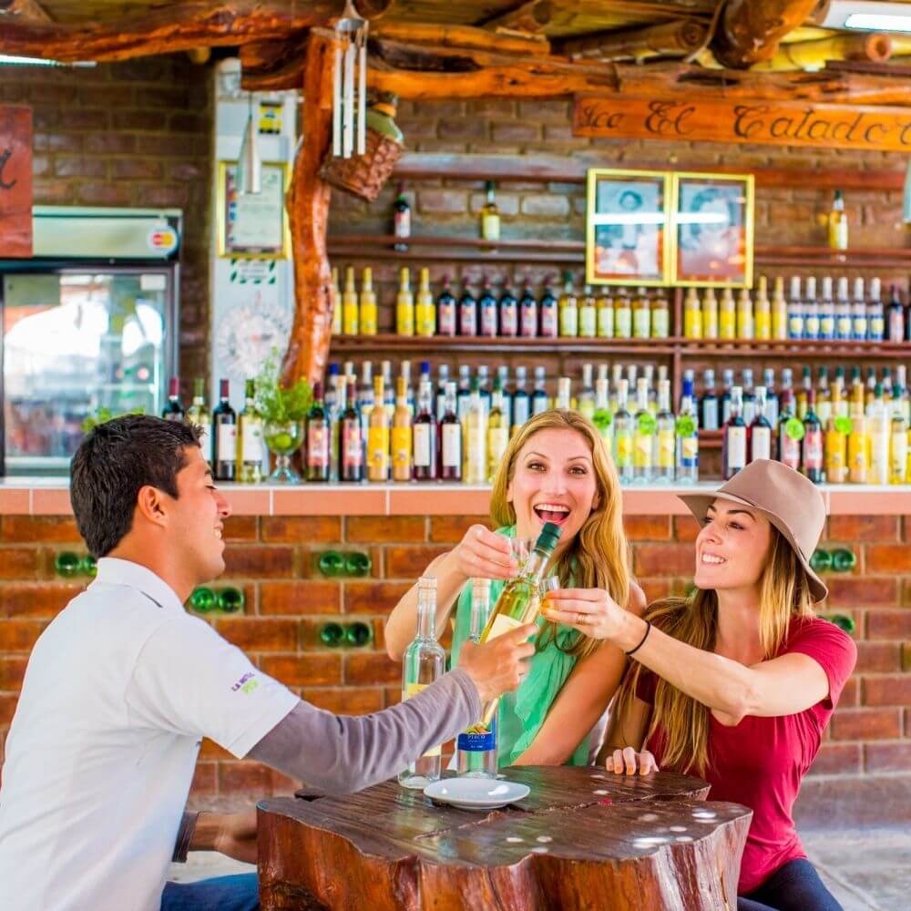 Travelers enjoying a traditional Pisco tasting at a vineyard in Ica during a Huacachina and Paracas 2-day tour in Peru.