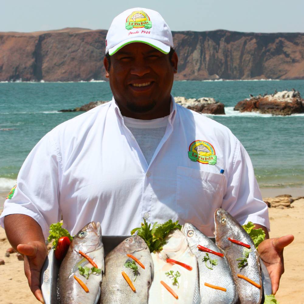 Traditional seafood experience in Paracas, Peru, featuring fresh local fish by the Pacific coast.