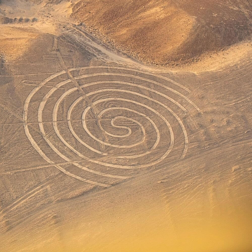 Nazca Lines spiral geoglyph carved into the desert of Peru during a scenic Nazca Lines flight tour.