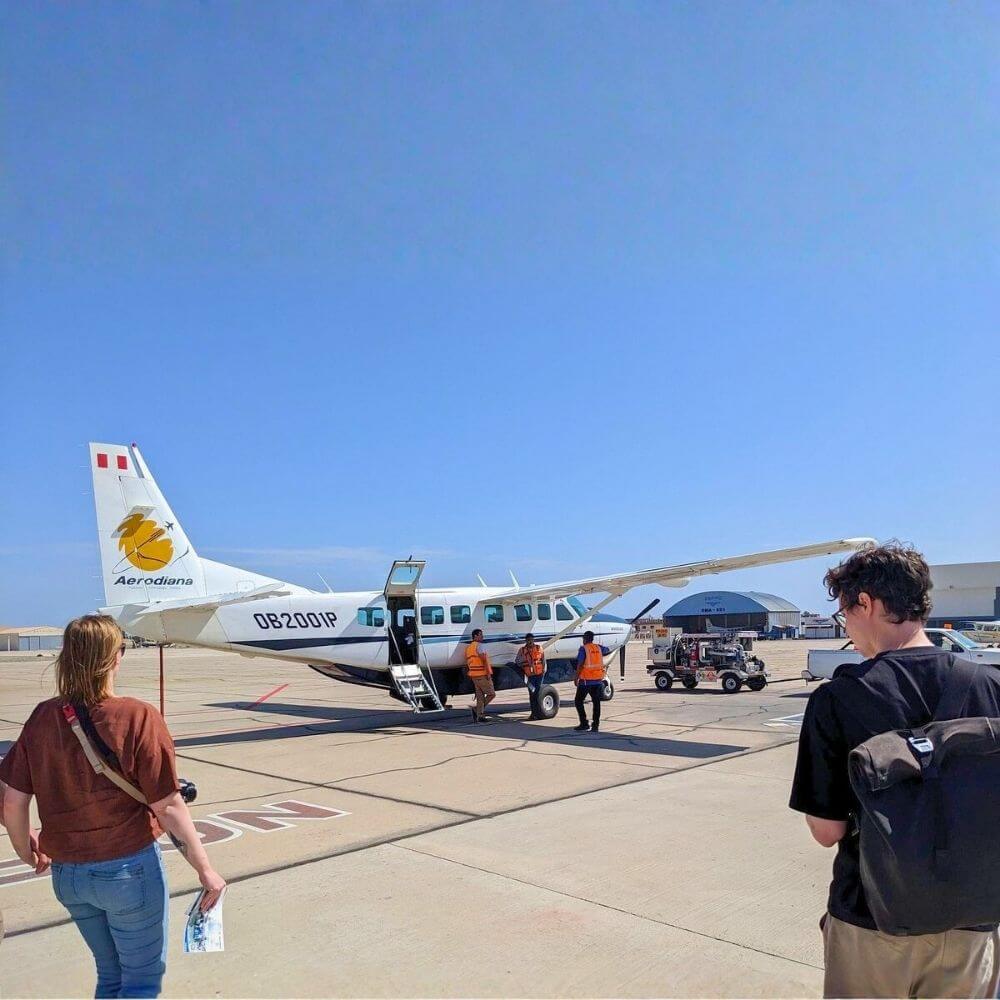 Travelers approaching a Cessna Caravan aircraft before their Nazca Lines flight from Pisco Airport, Peru.
