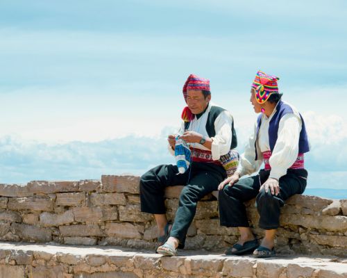 Taquile men knitting on Taquile Island.