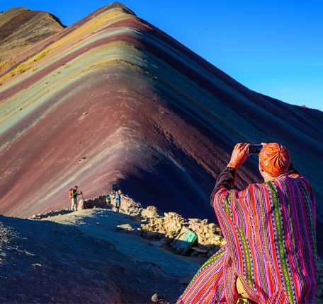 Visitors capturing the vibrant colors of Rainbow Mountain.