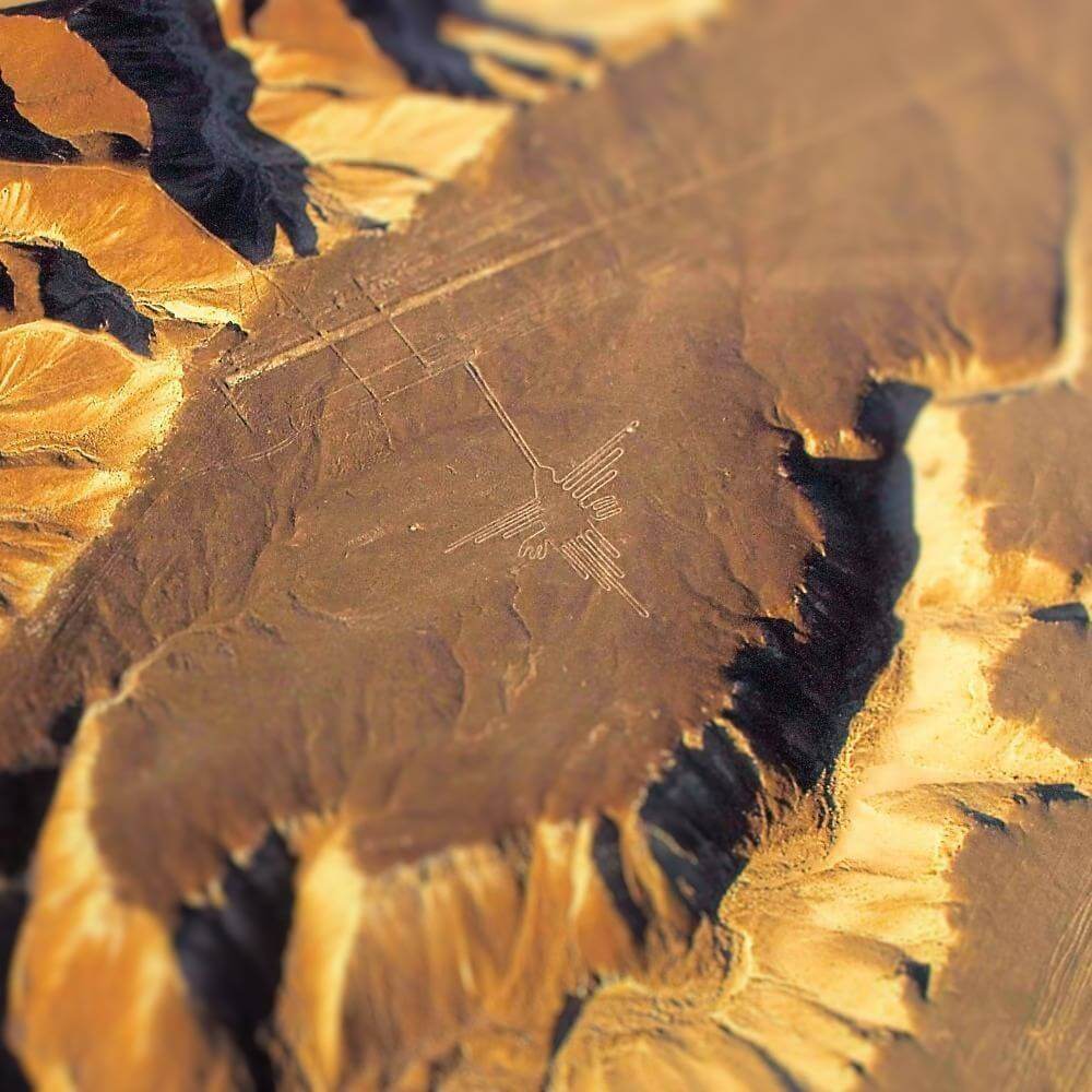 Aerial view of the famous Nazca Hummingbird geoglyph etched into the Peruvian desert, one of the most iconic Nazca Lines.