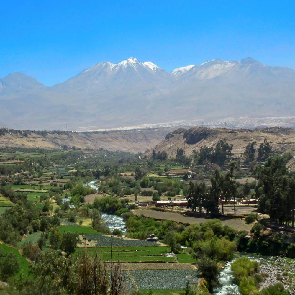 Panoramic view from Carmen Alto Viewpoint overlooking the Chili Valley, ancient agricultural terraces, and the Misti, Chachani, and Pichu Pichu volcanoes during the Arequipa Countryside Tour.
