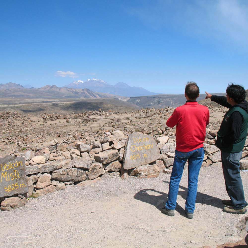 Travelers admiring the volcanoes from the Andes Viewpoint on the Colca Canyon Tour from Arequipa, Peru.