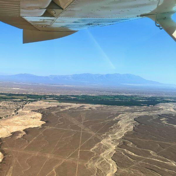 Aerial view of Nazca Lines geometric figures in the desert.