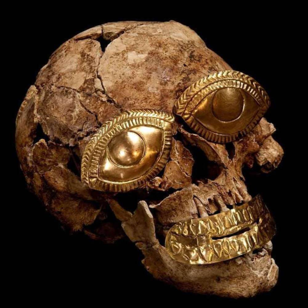 Ancient skull of the Lord of Sipán adorned with gold funerary ornaments at the Royal Tombs Museum in Lambayeque.