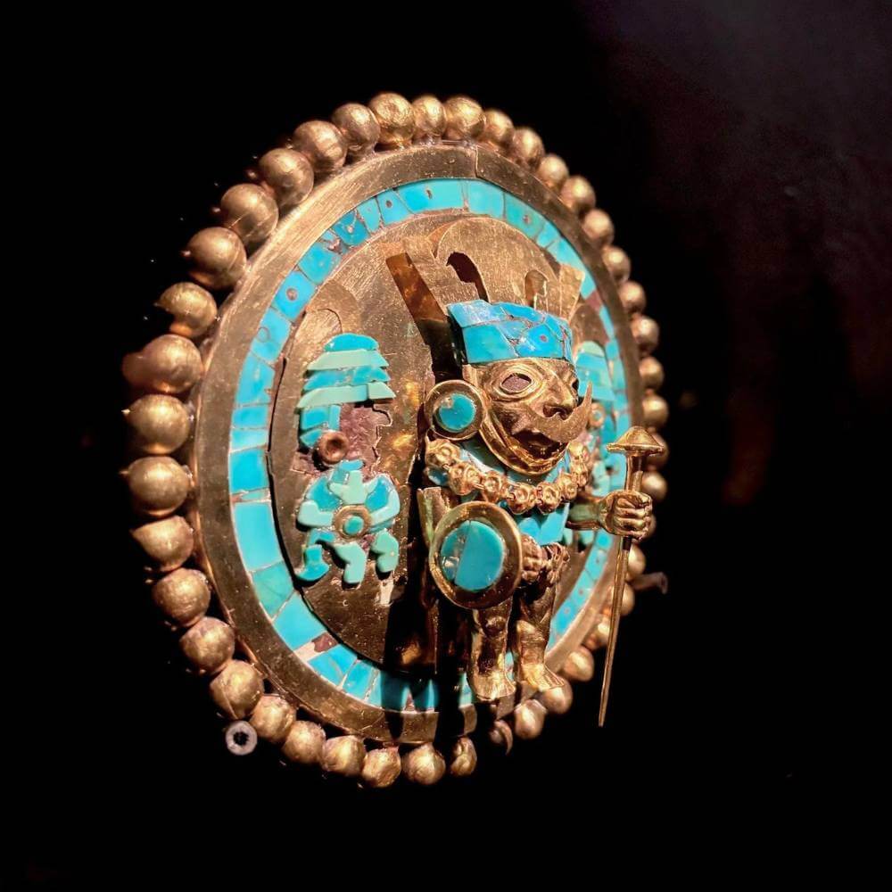 Gold and turquoise ceremonial ornament displayed at the Royal Tombs of Sipán Museum in Lambayeque, Peru.