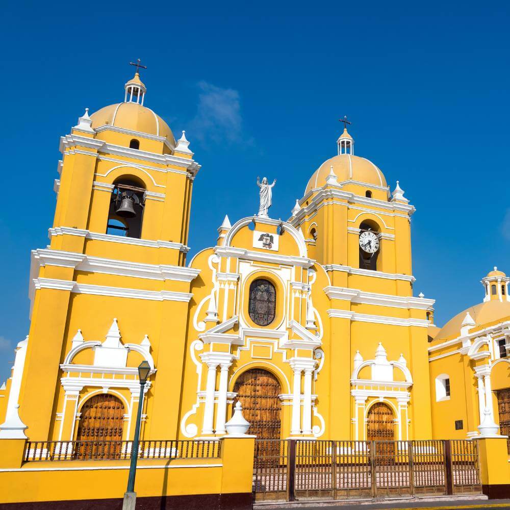 Yellow façade and twin bell towers of Trujillo Cathedral in the historic center of Trujillo, Peru.