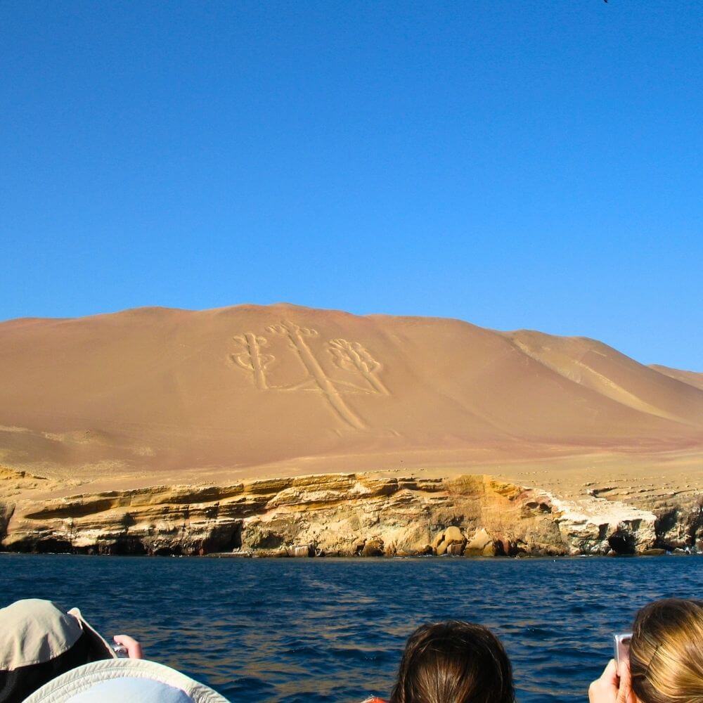 Candelabra geoglyph carved into the Paracas Peninsula viewed during a Ballestas Islands boat tour in Peru.
